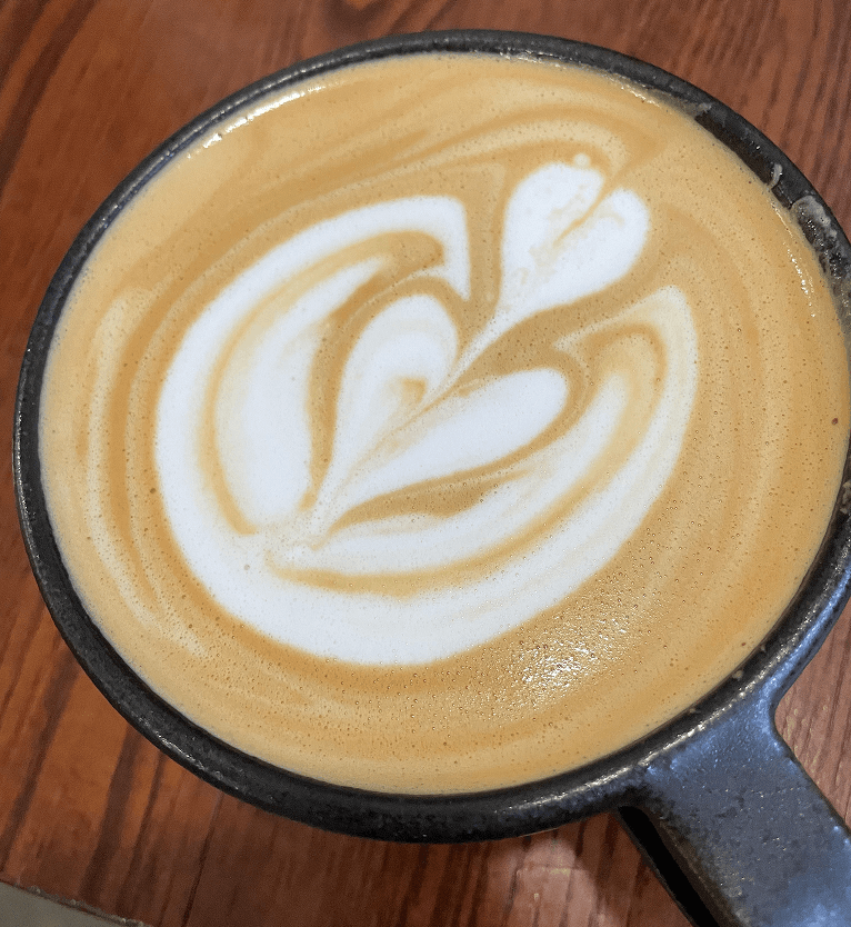 Latte art in a cast iron mug