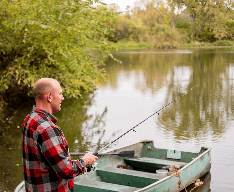 Team member fishing from a boat