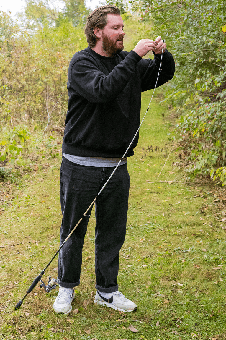 Team member rigging a fishing line outdoors